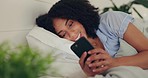 Phone text, happy woman and bed of a young female texting on a social media app in the morning. Wifi, web networking and happiness of a young person with a smile in a house reading a message