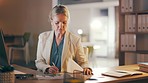 Night business, woman and documents with computer, planning graphs and stock market trading in dark office. Female worker, overtime and typing on desktop, writing paperwork or research data analytics