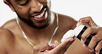 Skincare, cosmetics and man with shaving cream, grooming and hygiene against a grey studio background. Latino male, happy guy and facial foam for hair removal, wellness and product for beard and face