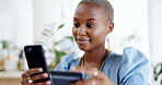 Phone, credit card and black woman online shopping in office for payment, digital banking or purchase. Business, fintech and smile of happy African female with mobile smartphone for ecommerce website