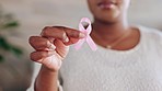 Breast cancer, pink ribbon and hands of black woman with symbol for awareness, testing and health check. Healthcare, medical care and girl holding bow, sign and icon for disease prevention or support