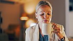 Business, woman and blowing coffee in office at night while working in professional startup company. Female worker blow on hot cup of tea in dark for energy, caffeine break and corporate deadlines 