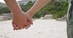 Holding hands, love and couple walking in a beach together bonding on vacation or holiday in Cape Town. Shore, summer and closeup of lovers walk on sea sand with trust, support and care