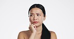 Skincare, thinking and Asian woman in a studio with a beauty, self care and natural routine. Question, doubtful and portrait of a female model with dermatology facial treatment by white background.