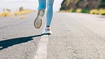 Running, sports and feet of woman on road in action for exercise, marathon training and workout. Fitness mockup, motivation and legs of female athlete on street for wellness, healthy life and cardio