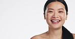 Face, asian woman and laughing for beauty in studio, isolated white background and mockup space. Portrait, happy female model and advertising mock up of dermatology, skincare or cosmetics coming soon