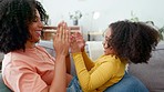 Happy, playing and mother and child on the sofa for bonding, game and quality time. Smile, playful and mom and girl kid together for play, happiness and enjoying hand games on the living room couch