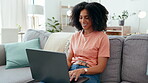 Remote worker, laptop and woman typing on sofa in home living room working on email. Technology, computer and smile of happy female professional or freelancer writing, research or internet browsing.