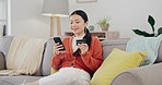 Happy woman, credit card and phone on couch online shopping, ecommerce and fintech easy payment. Asian person in China typing bank information on cellphone for discount or finance transaction at home