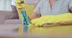 Woman, hands and detergent for housekeeping wiping table to clean surface, sanitize or disinfection at home. Hand of female cleaner or maid washing counter with spray bottle or sanitizer for hygiene