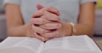 Closeup, bible and hands for praying, spiritual practice and guidance for problems, issue and peace. Zoom, hand and religious scripture for faith, believer or holy book for help, prayer or motivation