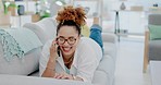 Laughing, relax and woman on a phone call on the sofa for conversation, catching up and communication. Happy, stress relief and girl answering a mobile for discussion, connection and speaking