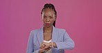Upset, late and black woman with a watch in a studio checking the time with disappointment. Mad, annoyed and portrait of African female model with a schedule or deadline isolated by purple background