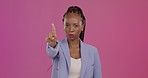 Hand gesture, no and finger with a black woman in studio on a pink background for negative or disagreement. Portrait, warning and reject with an unhappy female looking serious, upset or frustrated