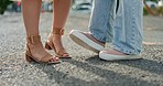 Feet, closeup and women in a road, shy and flirting while on their first date in a city. Shoes, lgbtq and lesbian couple sharing cute, romance and gay relationship, bonding and standing in a street