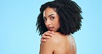 Hand on shoulder, skincare and face of black woman for beauty, body wellness and glow on blue background. Dermatology, spa and portrait of confident girl in studio for cosmetics, makeup and hair care