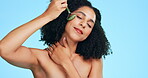 Beauty, massage and jade roller with black woman in studio for relax, skincare and cosmetics. Self care, glow and satisfaction with girl model on blue background for treatment, natural and facial