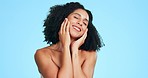Hands on face, beauty and black woman with smile for skincare, wellness and facial on blue background. Dermatology, spa satisfaction and portrait of girl in studio for cosmetics, makeup and hair care