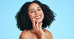 Skincare, beauty and black woman touch face with smile, wellness and facial treatment on blue background. Dermatology, spa and portrait of happy girl in studio for cosmetics, makeup and hair care