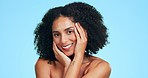 Beauty, hands on face and black woman with smile for skincare, wellness and facial on blue background. Dermatology, spa and happy confident girl in studio for cosmetics, makeup portrait and hair care