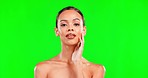 Beauty, makeup and portrait of a woman on green screen background for cosmetic skin glow. Aesthetic female model hand on face for self care, skincare and facial product for spa mockup studio space