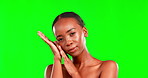 Face, skincare and a black woman on a green screen background in studio for natural or real beauty. Portrait, facial and chromakey mockup with an attractive young female touching her smooth skin