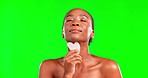 Black woman, beauty and gua sha in studio for skincare, cosmetics and dermatology. Face portrait of aesthetic female model on green screen for facial massage, self care and skin glow with a smile