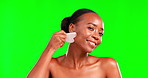 Beauty, gua sha and black woman portrait in studio for skincare, cosmetic and dermatology. Face of aesthetic female model on green screen for facial massage, self care and skin glow with a smile