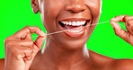 Closeup mouth, teeth and woman in studio for dental, cleaning and hygiene against green screen background. Oral, zoom and hands of girl flossing for fresh, clean and breath, routine and prevention