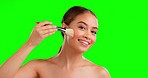 Makeup, brush and face of woman i n studio for beauty, glamour and cosmetics on green screen background. Portrait, tool and girl happy, smile and relax with luxury makeover, treatment and foundation