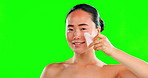 Face, beauty skincare and woman with stone on green screen in studio isolated on a background mockup. Dermatology, massage and happy Asian female model with rose quartz gua sha for skin treatment.
