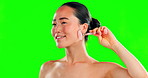 Beauty skincare, face and Asian woman with roller on green screen in studio isolated on a background mockup. Dermatology, massage and happy female model with rose quartz for facial skin treatment.
