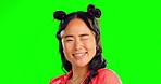 Asian woman, wink and face with green screen in a studio feeling confident with chroma key. Portrait, young female and happiness of a gen z person winking with humor and laughing with a smile