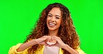 Happy woman, heart hands and face in studio, background and green screen for care, kindness or emoji. Portrait, laughing model and finger shape of love, thanks and smile of trust, peace and hope icon