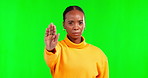 Portrait, stop and hand gesture with a black woman on a green screen studio background for gender equality. Palm, warning and protest with an angry female saying no to gender based violence