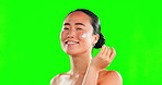 Face, beauty skincare and Asian woman with cream on green screen in studio on a background. Dermatology, cosmetics portrait and happy female model apply creme, lotion or moisturizer for healthy skin.