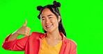 Asian woman, face and thumbs up in studio, smile and bonus winner on green screen. Portrait of happy female model celebrate with thumb, like emoji and winning excited achievement, vote and thank you