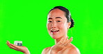 Skincare, face and woman with cream container on green screen in studio isolated on background. Beauty dermatology, cosmetics portrait or funny Asian female model apply product, lotion or moisturizer