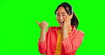 Surprise, pointing and woman in studio with green screen and mockup space for advertising. Shock, amazed and portrait of a Asian female model with showing gesture for mock up by chroma key background