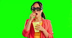 Green screen film and woman in glasses, 3d cinema experience and eating popcorn isolated on studio background. Asian person face watch movies or video in vr sunglasses, virtual reality or metaverse