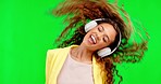 Headphones, dancing and excited woman with green screen in studio with chromakey background. Music, streaming and dance, happy person having crazy fun with online radio station or party celebration.