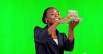 Black woman, blowing cash and celebration on green screen for winning lottery or prize against studio background. Happy African American female playing with money for sale, win or discount on mockup