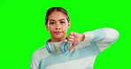 Thumbs down, green screen and face of a gen z girl with headphones with no vote. Decision, opinion and negative voting hand sign of a young and annoyed teenager shaking head for a disagreement 