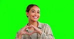 Face, woman and heart sign with green screen, support and smile with joy, solidarity and cheerful. Portrait, female and lady with symbol for love, happiness and motivation against a studio background