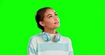 Headphones, green screen and woman thinking, ideas and thoughts against studio background. Female, headset or lady with wonder, daydreaming and ponder with decision, choices and thoughtful with smile