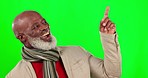 Mockup, green screen and black man pointing up, happiness and cheerful against a studio background. African American male, mature guy and gesture for space, showing and product placement on backdrop