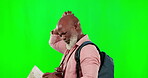 Black man, lost and map on green screen while confused with a backpack. African senior male model on studio background with mockup space for travel, navigation and direction while walking on journey