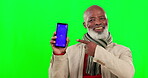 Black man, phone and green screen with mockup in studio isolated on a background. Cellphone, product placement and face portrait of happy senior person with marketing or advertising tracking markers.