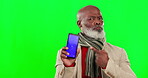 Black man, phone and green screen with mockup pointing in studio isolated on a background. Cellphone, serious and face portrait of person with marketing or advertising tracking markers shaking head.