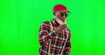 Dance, music and a senior black man on a green screen background in studio having fun moving with rhythm. Party, fashion and funky with a happy elderly man dancing on chromakey mockup for freedom